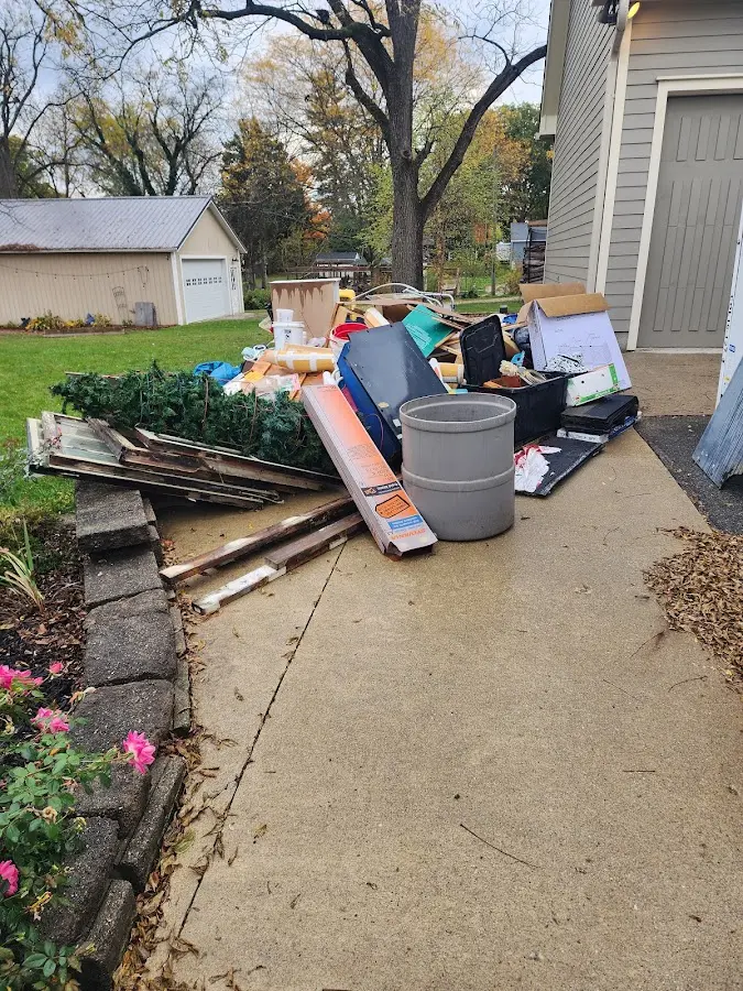 Dumpster being loaded with debris for Estate Cleanout Dumpster Rental in Snyderville